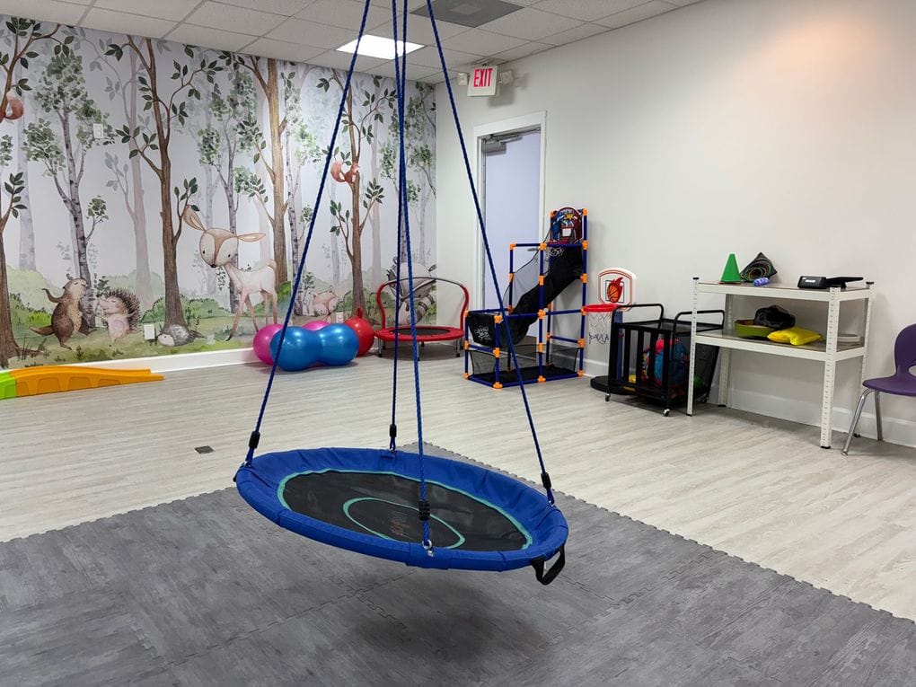 Therapy room set up for one-on-one sessions, with a child-height table and chairs