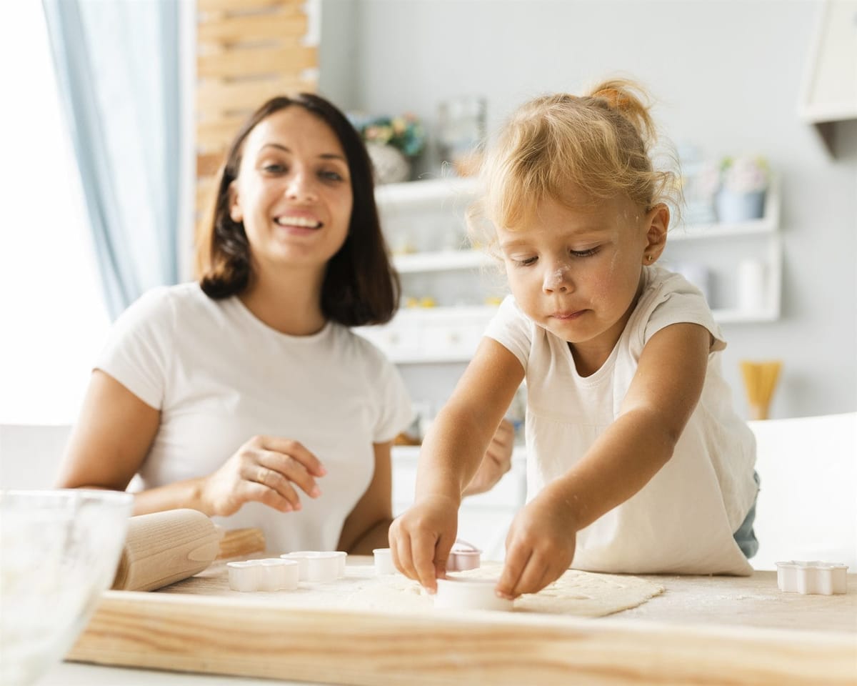 A mother and daughter baking cookies together at home